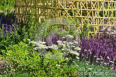 a beautiful perenial garden with bamboo ornament Stock Photo