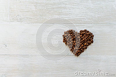 Beautiful shot of the coffee mug in the morning on the white wooden table with coffee heart shaped beans. Perfect for copy valent Stock Photo