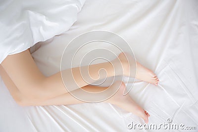 Beautiful perfect of woman legs slim sexy on bed at bedroom, skin smooth of beauty girl feet health care Stock Photo