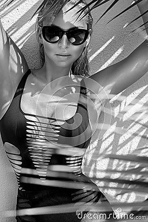 Beautiful phenomenal stunning elegant blonde model woman with perfect face wearing a sunglasses stands with elegant erotic sw Stock Photo