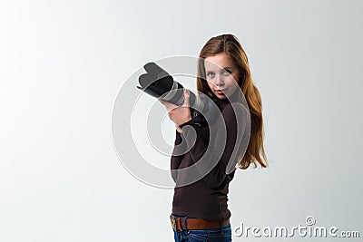 The beautiful photographer girl with professional dslr camera posing on a white background in studio. Photo learning Stock Photo