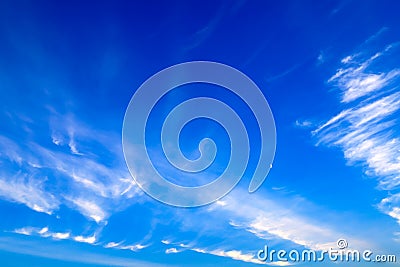 Beautiful picturesque white feather clouds on the blue sky with a young moon , magic romantic background Stock Photo
