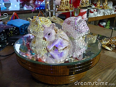 3 beautiful pig-shaped caskets with rhinestones on a mirrored stand. Stock Photo