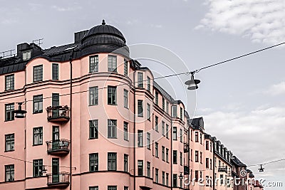 Beautiful pink building on cloudy sky background Stock Photo