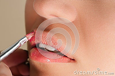 Beautiful pink gloss on lips Stock Photo