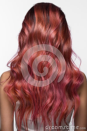 Beautiful pink-haired girl in move with a perfectly curls hair, Beauty salon Stock Photo