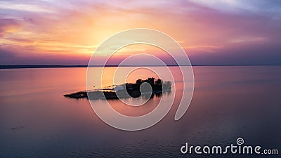 Beautiful pink sunset with sun rays over sea. Stock Photo