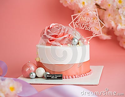 Beautiful pink and white cake with a big rose on top Editorial Stock Photo
