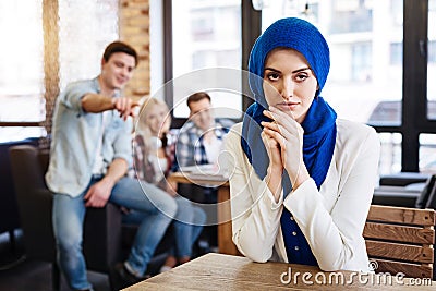 Beautiful pleasant muslim woman sitting in the cafe Stock Photo