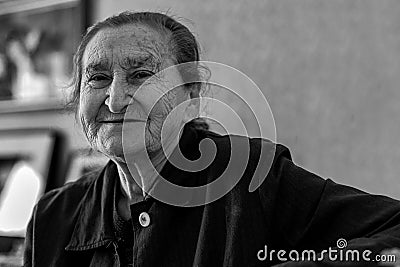 Beautiful 80 plus year old senior woman portrait. Black and white image of elderly woman smiling. Stock Photo