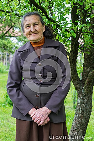 Beautiful 80 plus year old senior woman posing for a portrait in her garden Stock Photo