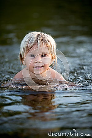 Beautiful portrait of child in lake, kid playing Stock Photo