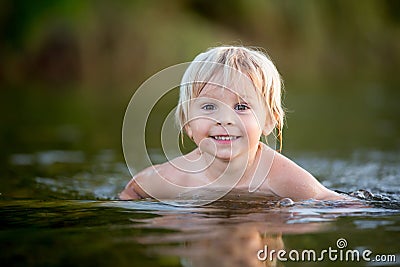 Beautiful portrait of child in lake, kid playing Stock Photo