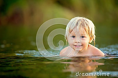 Beautiful portrait of child in lake, kid playing Stock Photo