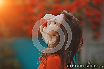 Beautiful portrait of sensual brunette woman holding red roses. Toned image Stock Photo