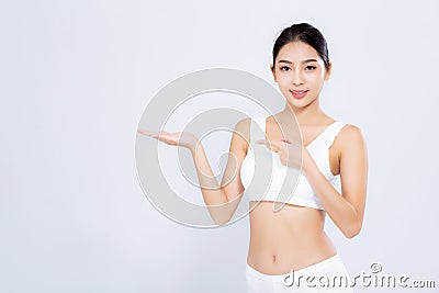 Beautiful portrait young asian woman fit smiling gesture showing presenting something empty on hand isolated Stock Photo