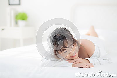 Beautiful portrait young asian woman lying and smile while wake up with sunrise at morning, beauty cute girl happy and cheerful Stock Photo