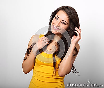 Beautiful positive happy woman in yellow shirt and long hair too Stock Photo