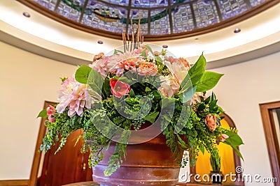 Beautiful potted colorful flowers with leaves under stained glass dome roof Stock Photo