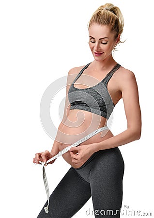 Beautiful pregnant woman measure big belly with tape measure Stock Photo