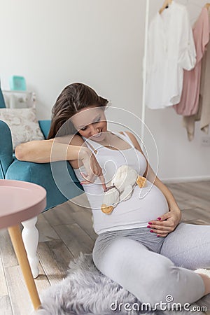 Pregnant woman holding baby toy Stock Photo