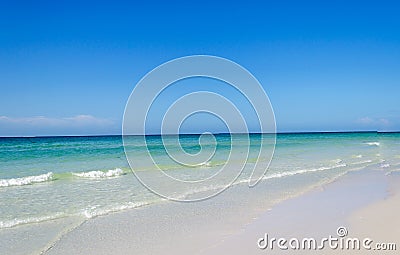 Beautiful pristine beach surrounded by blue sky Stock Photo