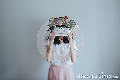 A beautiful purple bouquet in tha vase in the girl`s hands. Stock Photo