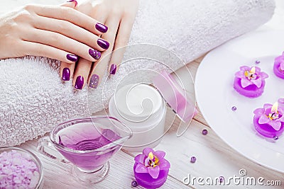 Beautiful purple manicure with spa essentials Stock Photo