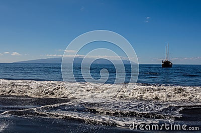 Beautiful and quiet Beach Masca. Pirate ship coming to the island.. Volcanic island. Mountains of the island of Tenerife Stock Photo