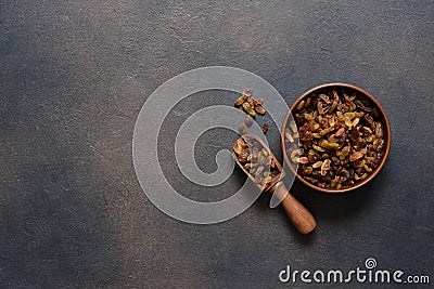 Beautiful raisins in a plate on a dark concrete background with place for text. View from above Stock Photo