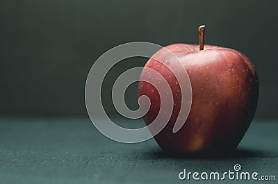 Beautiful red apple against a dark background, isolate Stock Photo