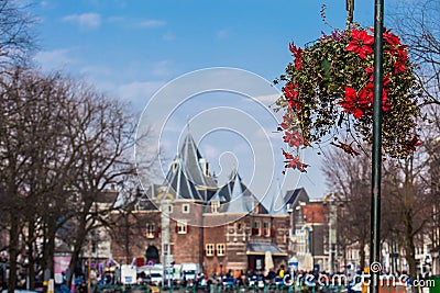 Beautiful red flowers embellish the bridges at the Old Central district in Amsterdam Stock Photo