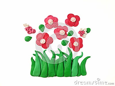 Beautiful bloom flower plasticine clay, red floral dough, green grass Stock Photo