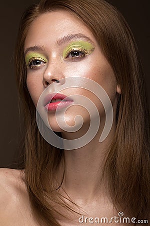 Beautiful red-hair girl with creative green makeup. Beauty face. Stock Photo