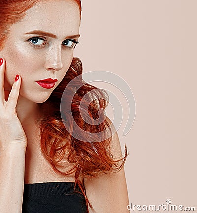 Beautiful red hair woman portrait with flower in hair perfect make up manicure Stock Photo