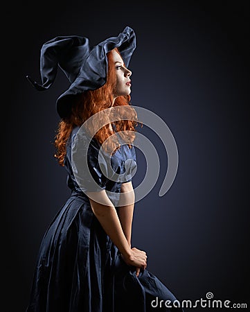 Beautiful red-haired girl in a costume witch Stock Photo