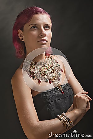 Beautiful red-haired young woman wearing a royal jewelry necklac Stock Photo