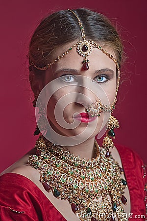 Beautiful red-haired young woman wearing a royal jewelry necklac Stock Photo