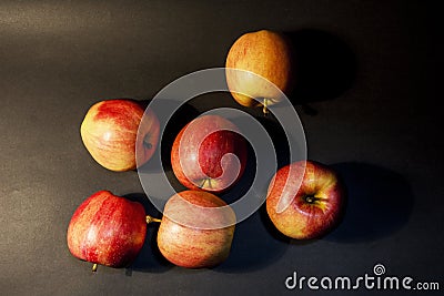 A beautiful red juicy apple. On a black background. One apple in the photo. Bright photo. Black Stock Photo