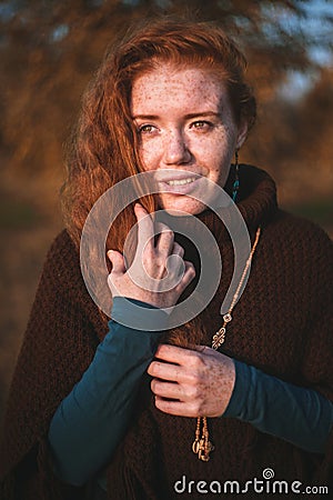 Beautiful redhaired girl at sunset. Stock Photo