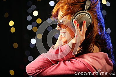 Beautiful redhead with headphones Stock Photo