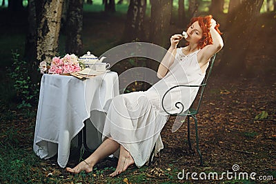 Beautiful redhead woman in surreal forest Stock Photo