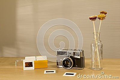 Beautiful retro camera and slides film on the table with morning light Stock Photo