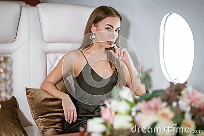 Beautiful rich woman in a private first class plane Stock Photo