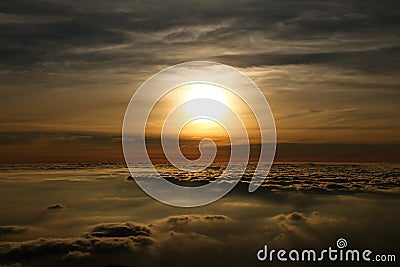 Beautiful rising sun glowing over the clouds Stock Photo