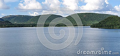 Beautiful river against the backdrop of mountains and blue skyline Stock Photo