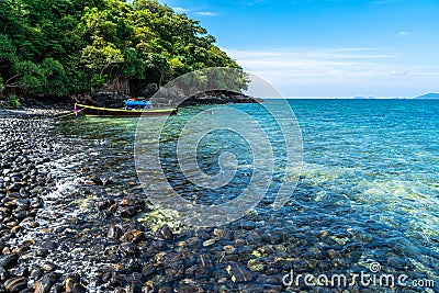 Beautiful rock beach with tourist long tail boat in Koh Hin Ngam, Tarutao National park, Thailand Stock Photo