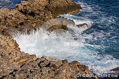 Beautiful rocky steep coast and big waves Stock Photo