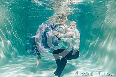 Beautiful romantic couple of lovers hugging gently under water Stock Photo