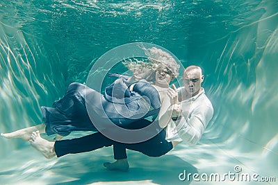 Beautiful romantic couple of lovers hugging gently under water Stock Photo